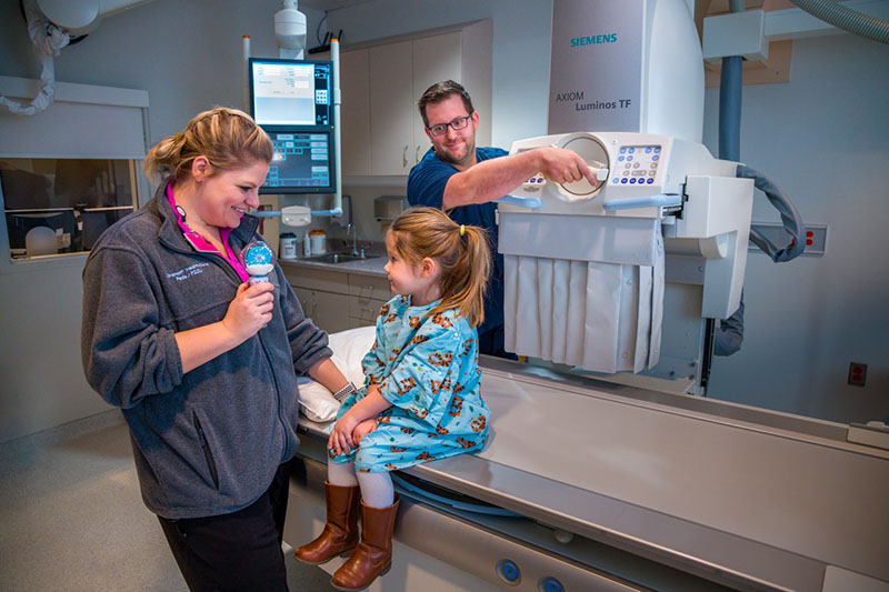 Covenant Child Life Specialist Mariah Bruff helps to relax pediatric patient while preparing for a procedure