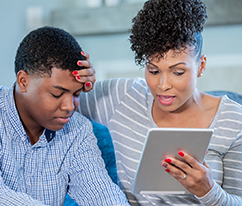 Woman with son on a virtual visit using a tablet