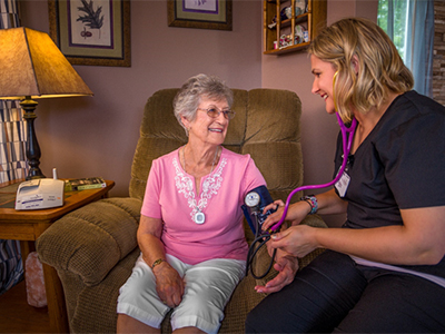 Nurse caring for patient in their home